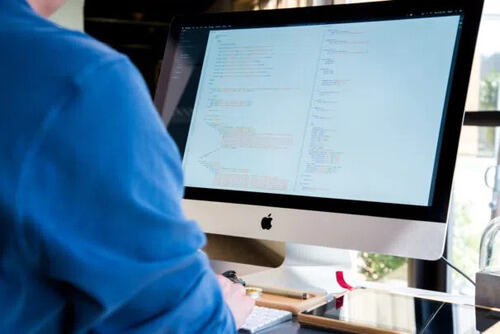 man doing coding on a computer