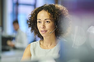 A woman wearing a headset.