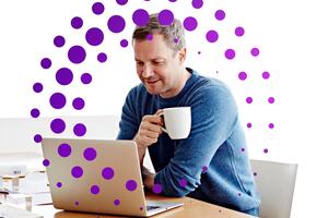 Man working at a laptop drinking coffee