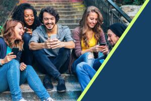 A group of happy people showing each other their phones