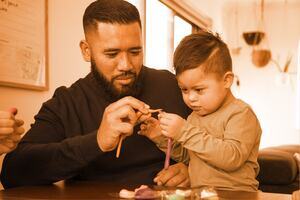 Father and son playing with play dough 