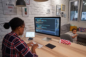 A woman working at a laptop