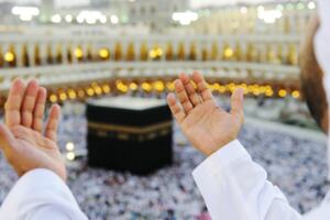 A person makes dua near Kaabah