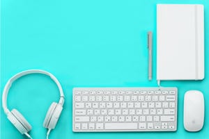 equipment needed to teach online. Keyboard, notebook, pen, headphones, mouse.