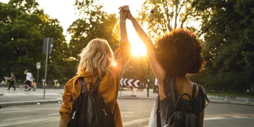 two feminists holding hands